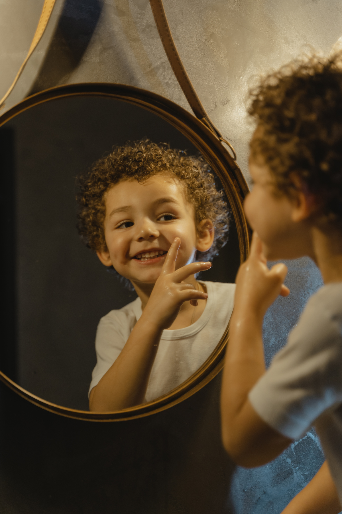 Boy Looking at a Wall Mirror